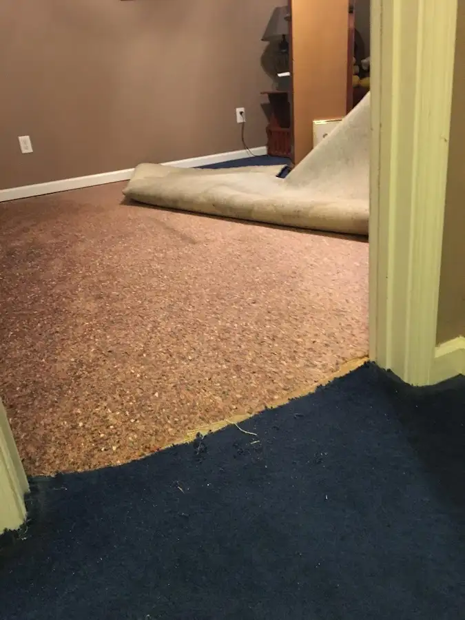 Carpet pad removal revealing water damage during Drying & Dehumidification in Appleton